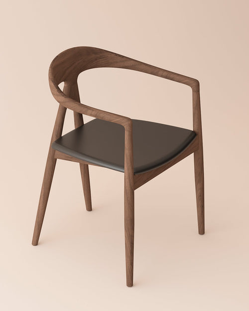 A modern wooden dining chair with a curved armrest, dark brown wood frame, and a dark gray upholstered seat, shown against a solid light beige background.