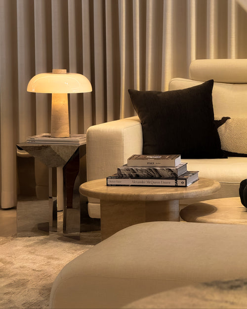 Modern living room with a beige sofa, coffee table, and side table.
