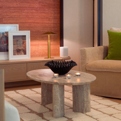 Modern living room with a coffee table, lamp, and couch.