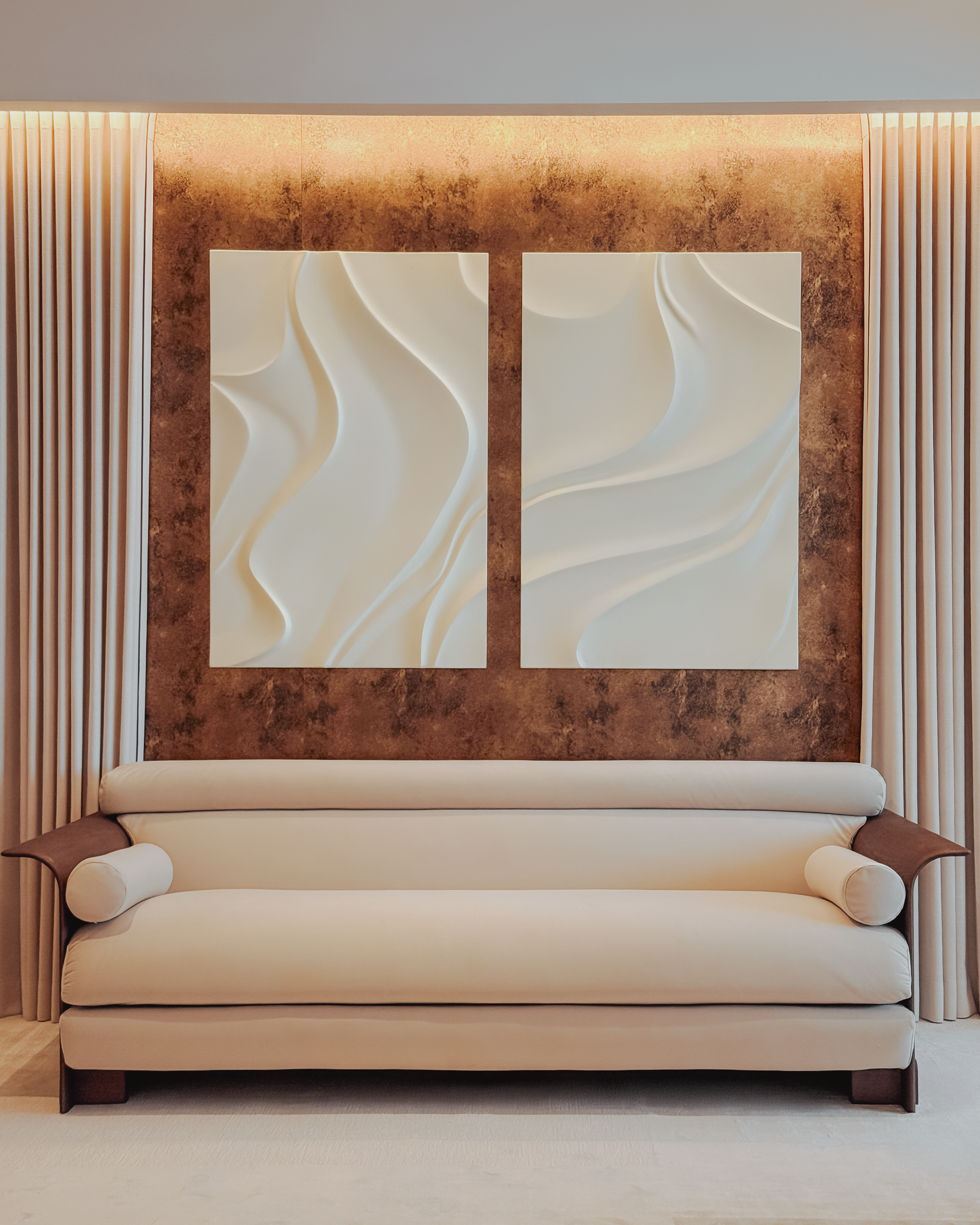 Beige sofa in a room with abstract wall art and curtains.