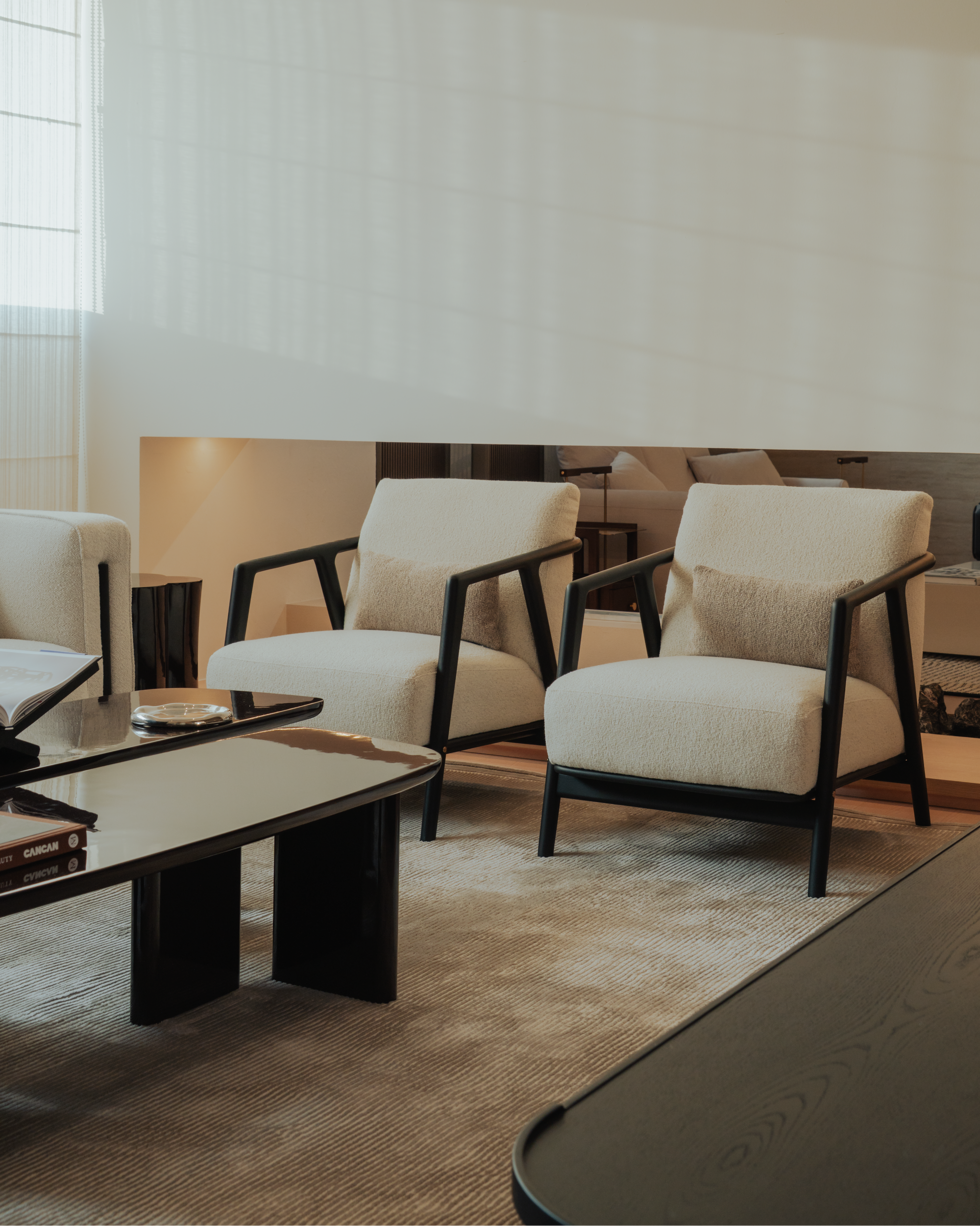 Modern living room with white chairs and a coffee table.