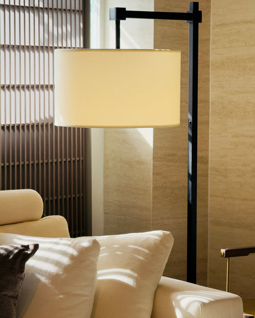 Floor lamp with a beige shade in a living room setting