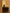 Dark wooden dresser with a lamp on a beige wall background