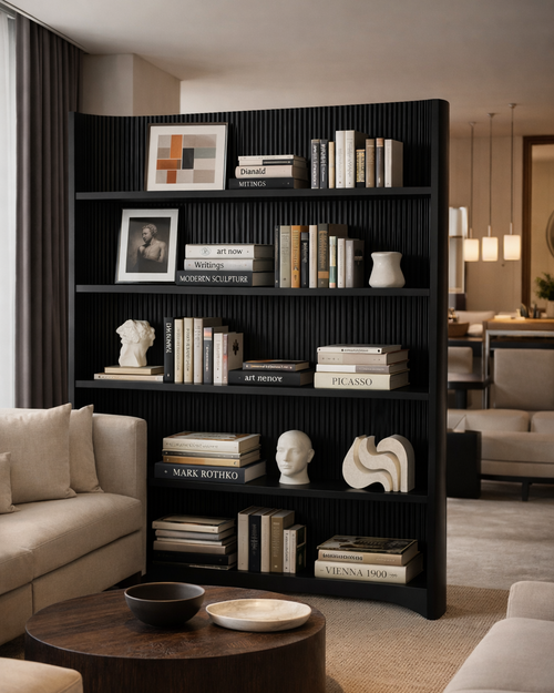 Black bookshelf in a living room with books and decorative items