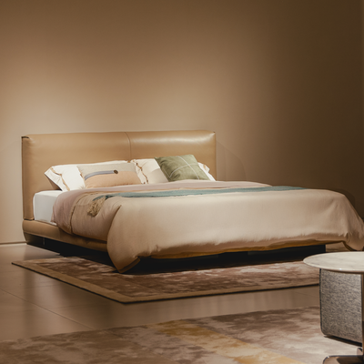 Beige bed with pillows in a minimalistic room