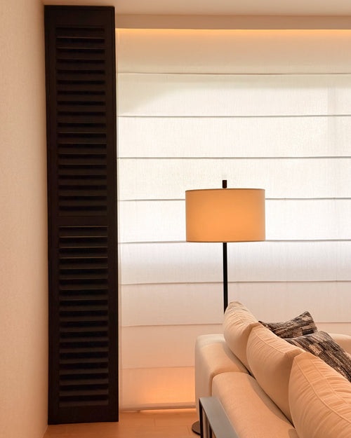 Modern interior with a lamp, sofa, and decorative elements.