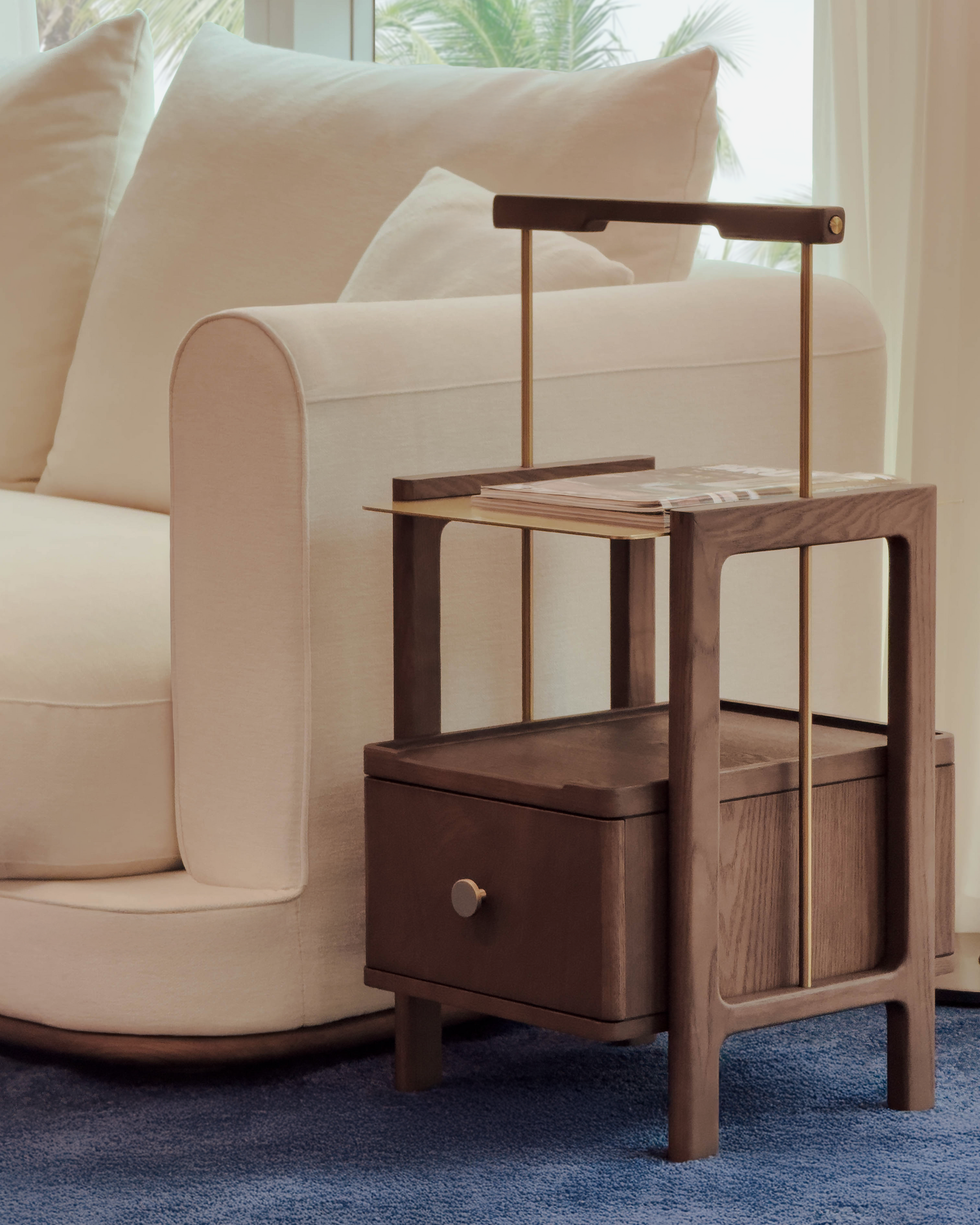 Wooden side table with a drawer in a living room setting