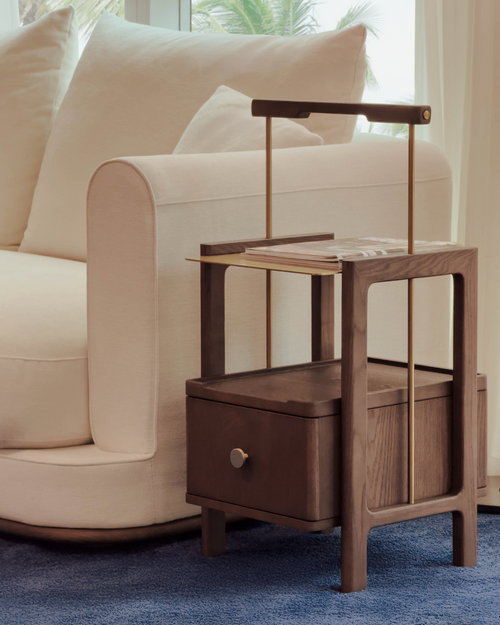 Wooden side table with a drawer in a living room setting