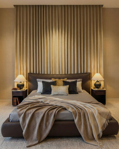 Modern bedroom with a large bed, side tables, and decorative pillows.