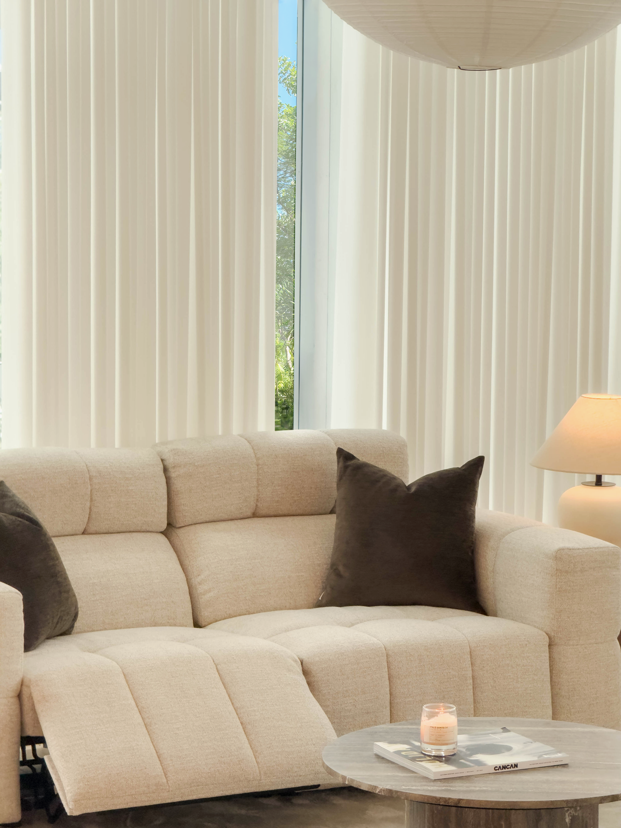 Beige sectional sofa with brown cushions in a living room setting.