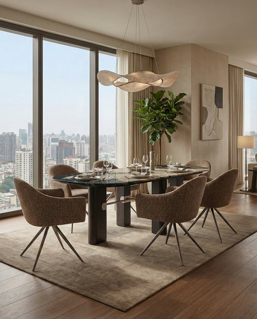Modern dining room with a round table and chairs near large windows with cityscape view.