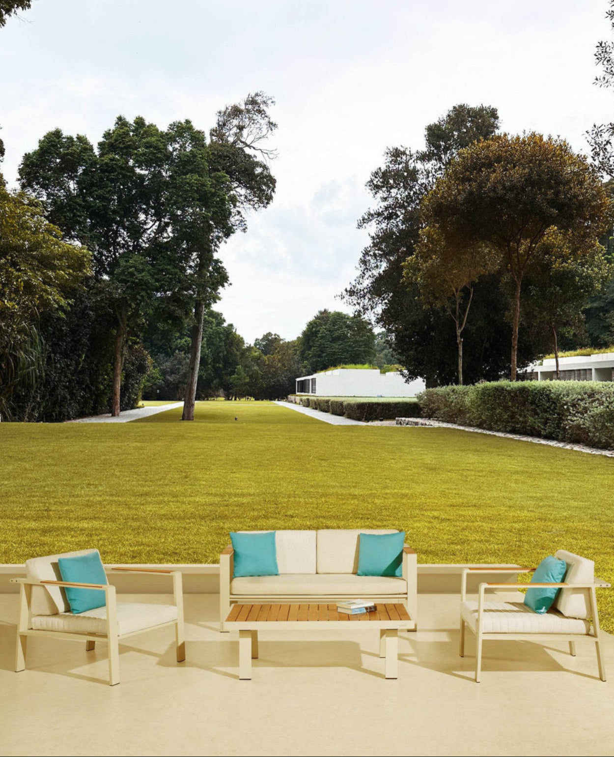 Outdoor patio set with cushions on a grassy area with trees in the background