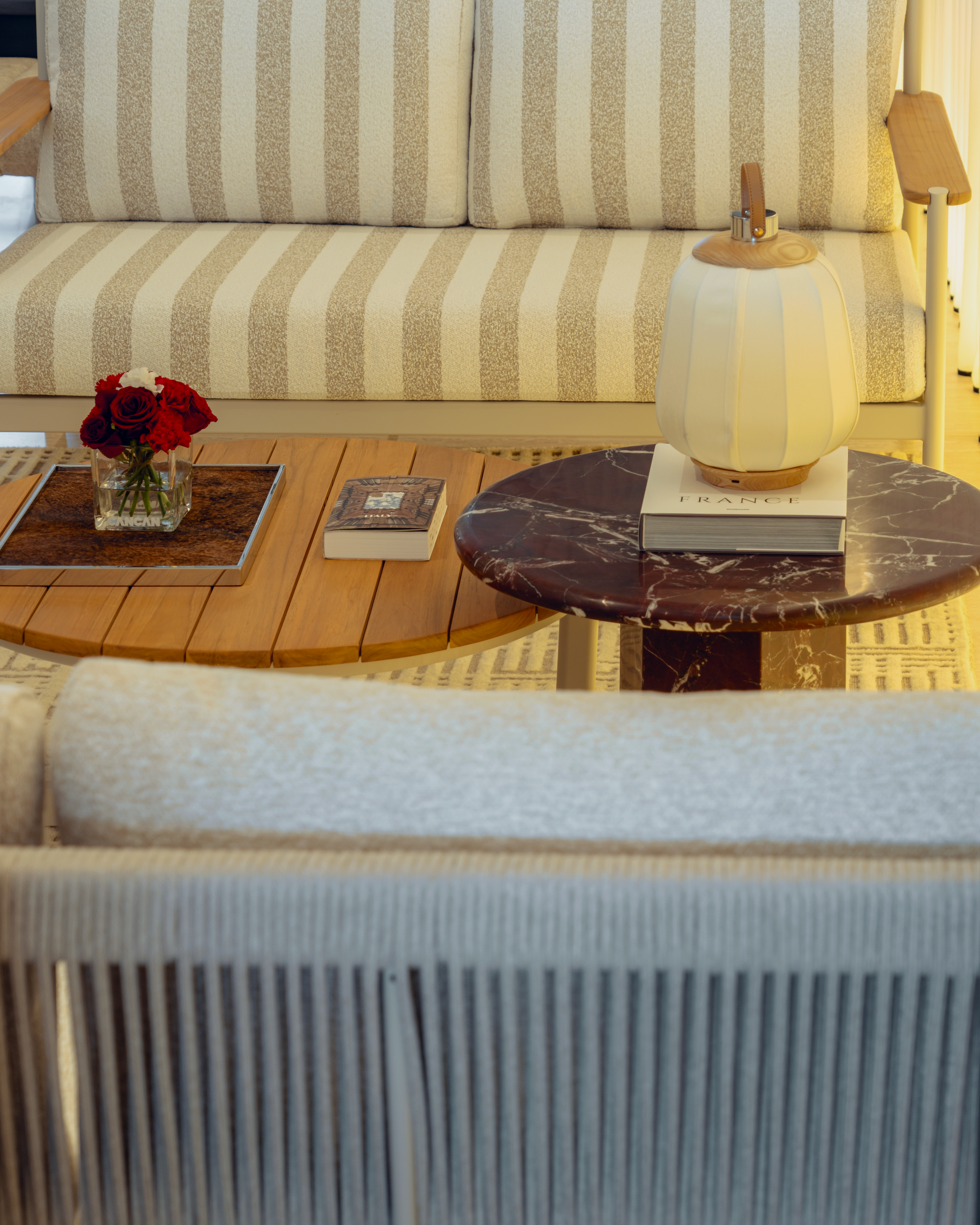 Living room with striped sofa, wooden coffee table, and decorative items.