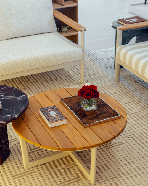 Wooden coffee table with decorative items in a living room setting