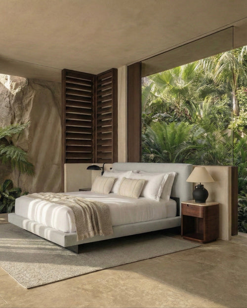 Modern bedroom with a large bed, nightstands, and a view of greenery outside.