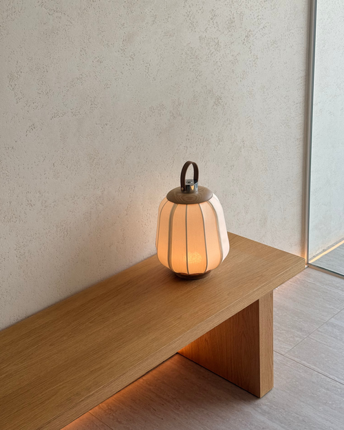 Small lamp on a wooden surface with a neutral background
