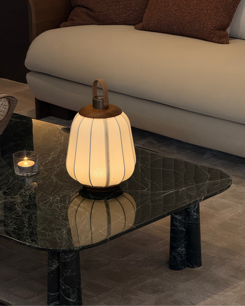 Decorative lamp on a coffee table with a couch in the background