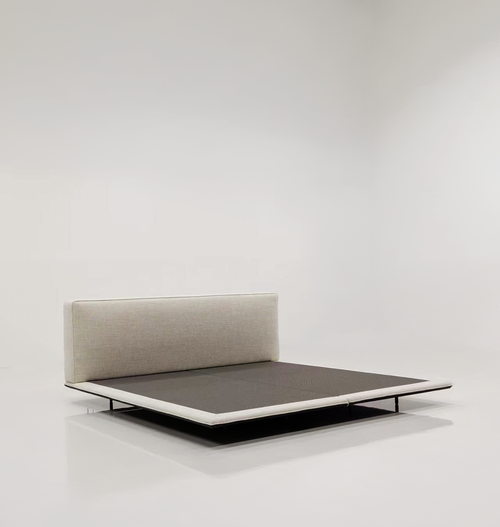 Modern bed with upholstered headboard on a white background