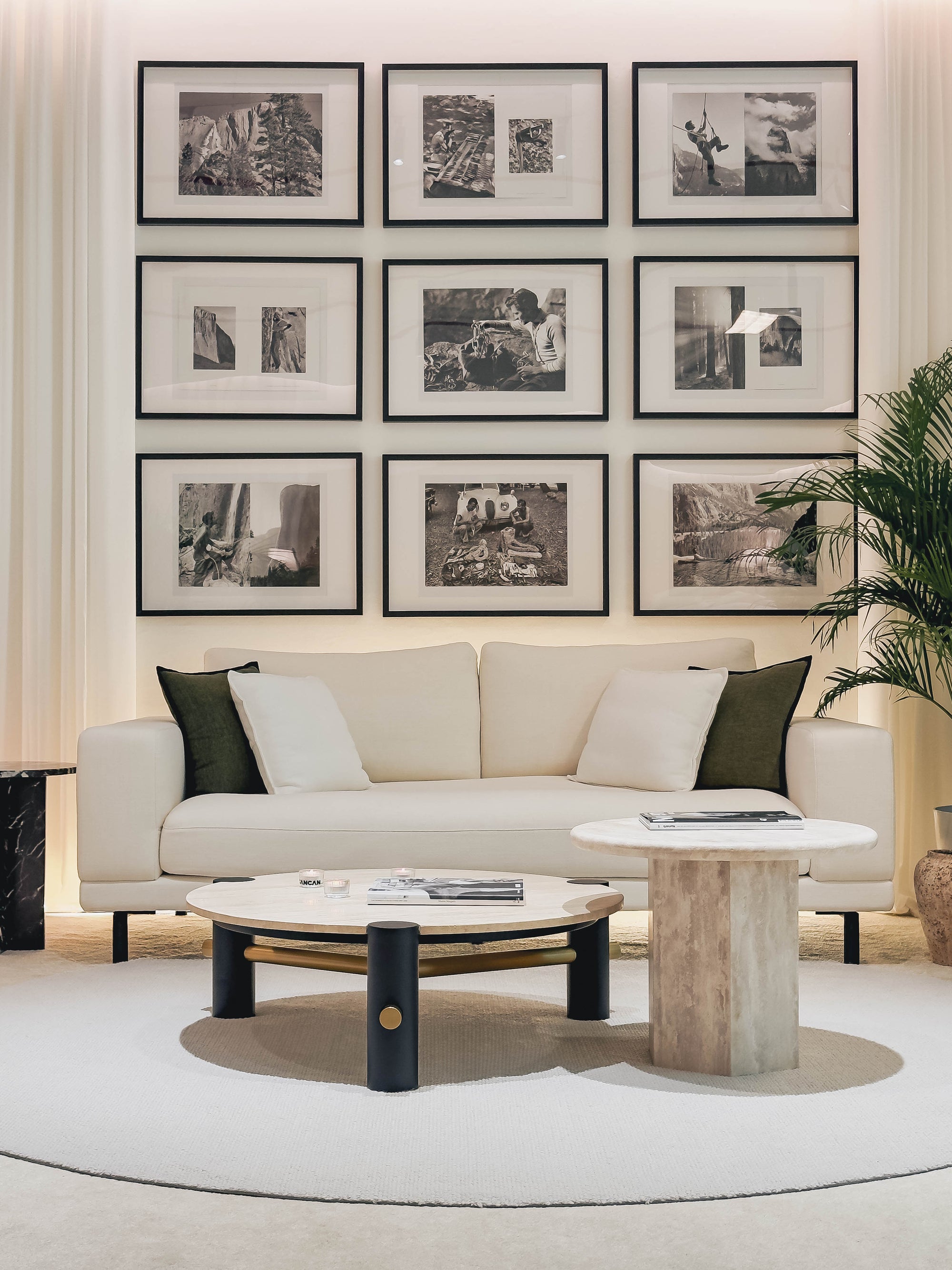 Modern living room with a beige sofa, round coffee table, and wall art.