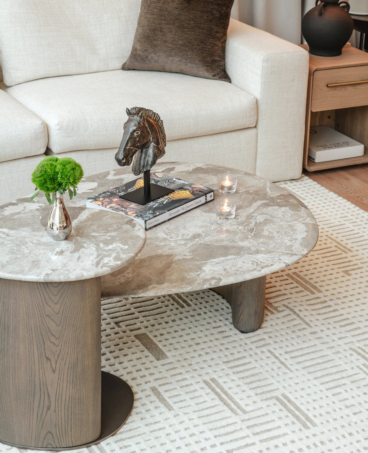 Living room with a marble coffee table, decorative items, and a couch.
