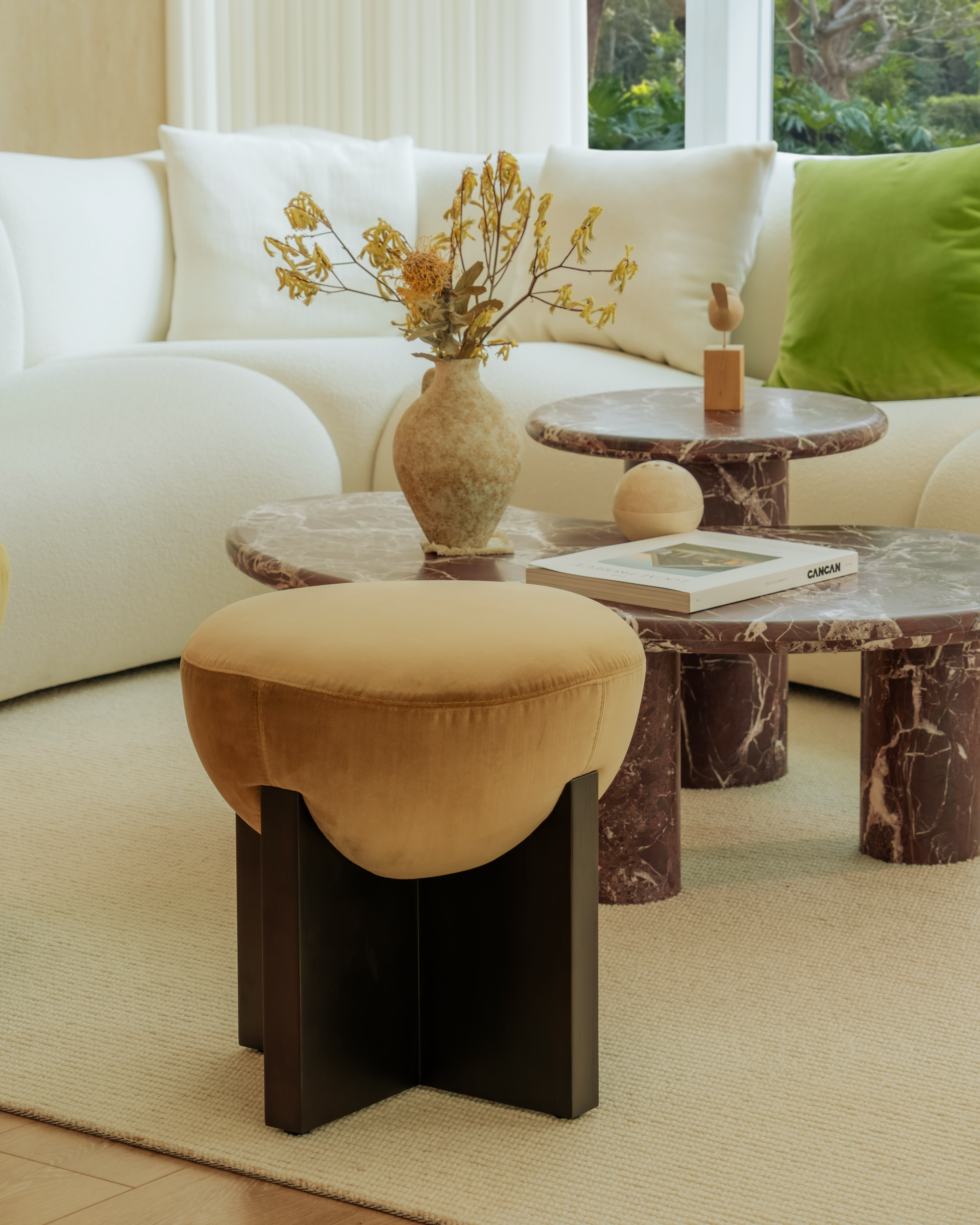 Living room with a white sofa, marble coffee table, and decorative items.