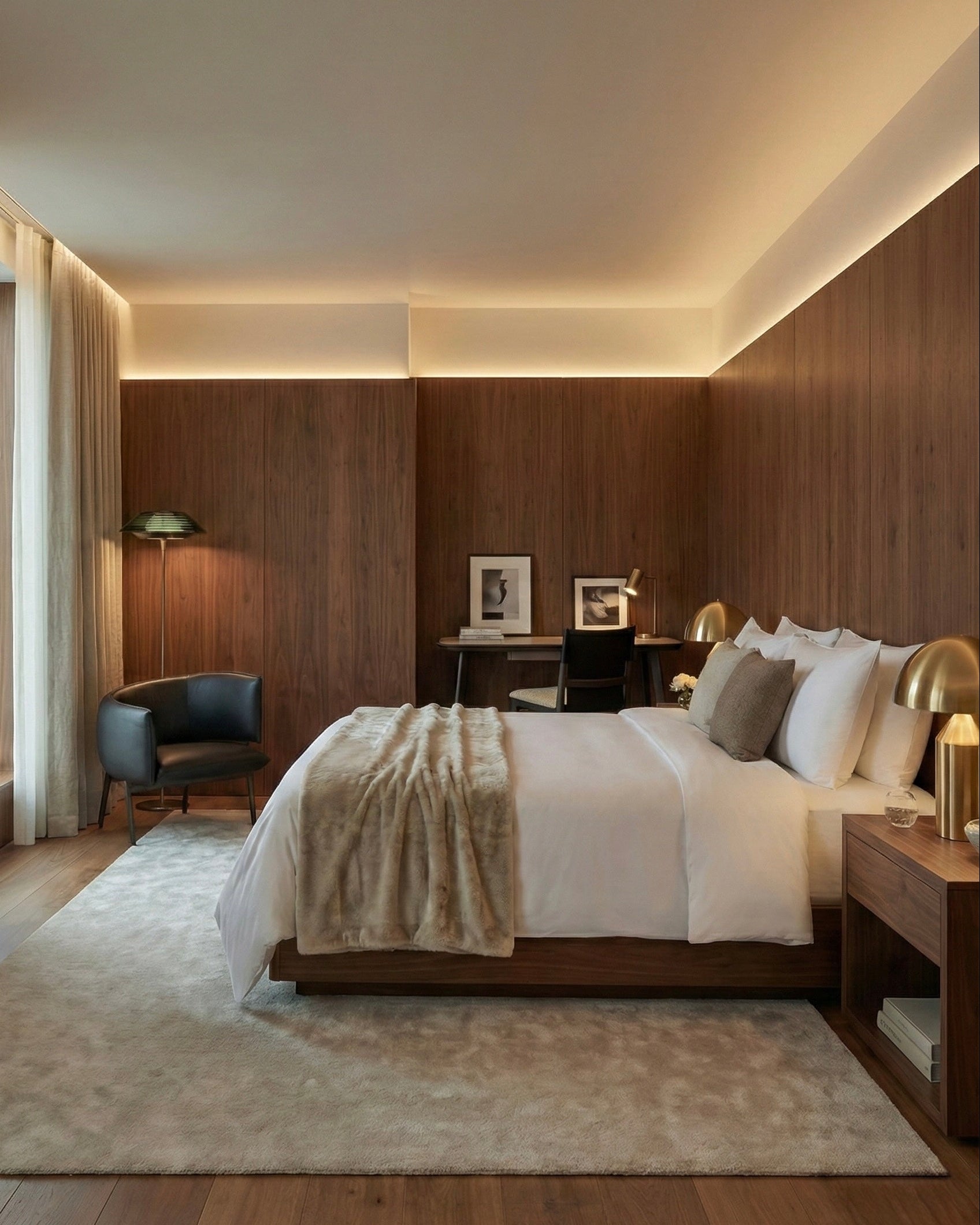 Modern bedroom with wooden walls, a bed, and decorative items.