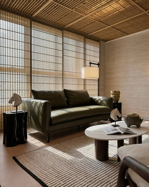 Modern living room with a green sofa, wooden coffee table, and decorative items.