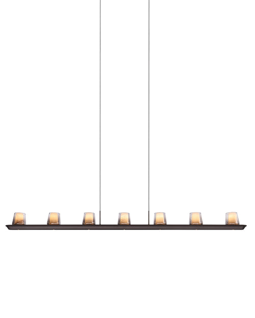 A modern linear chandelier with eight warm glowing glass shades on a long horizontal bar, suspended by two thin cables against a plain white background.