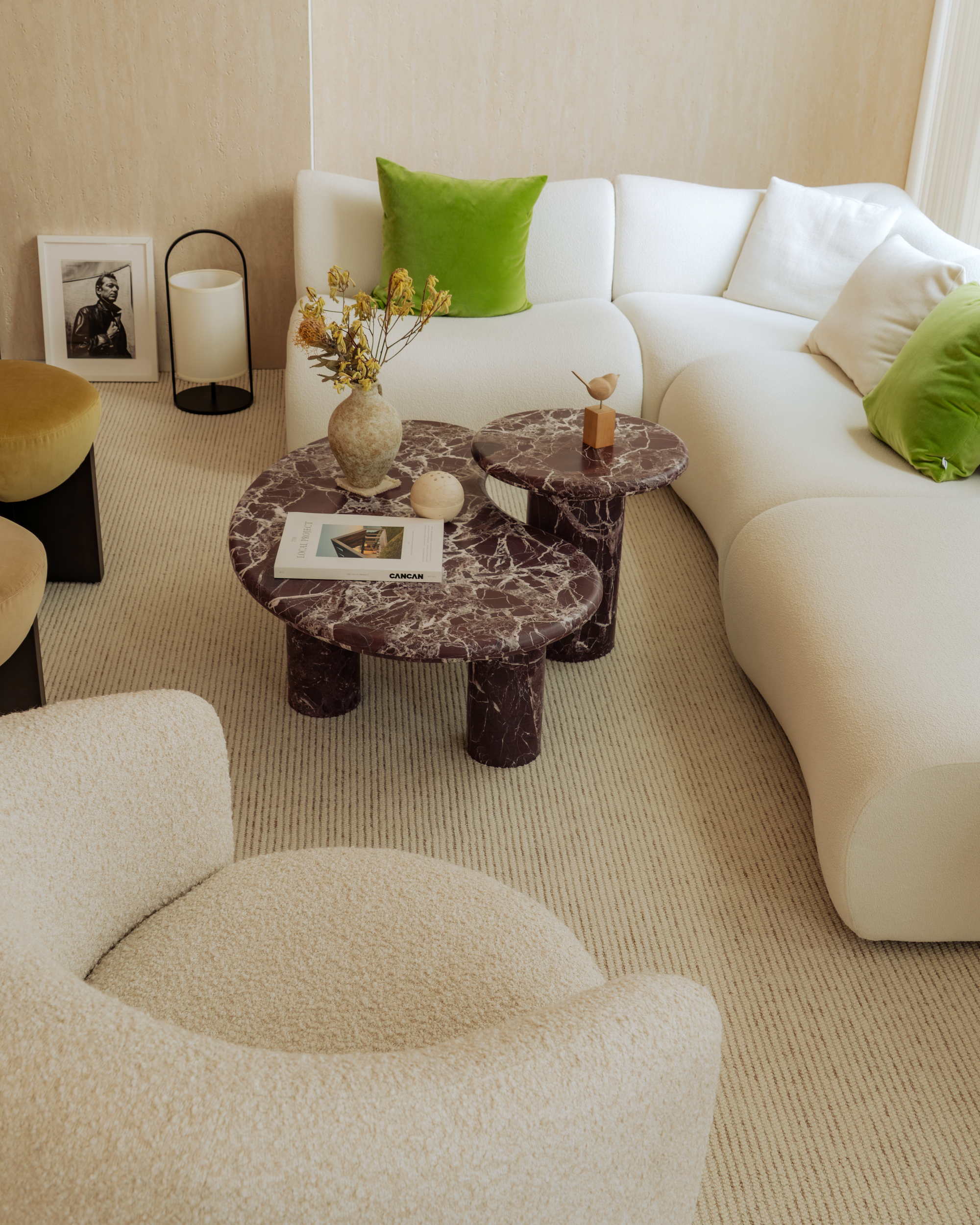 Modern living room with a white sofa, marble coffee table, and decorative elements.