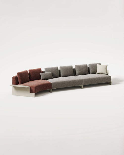 A modern sectional sofa with a left-facing chaise lounge, upholstered in a warm rust-brown fabric on the chaise and matching accent cushions, paired with a large gray upholstered body and a single off-white throw pillow, set against a seamless light gray studio background.