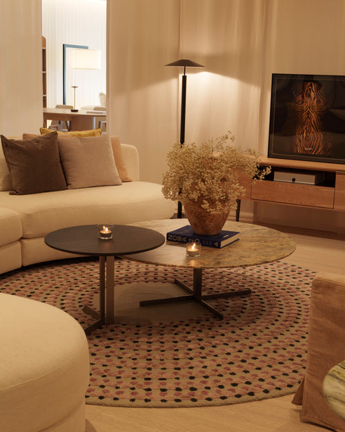 Modern living room with a sofa, coffee table, and decorative elements.
