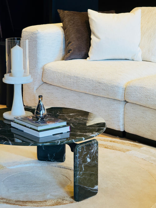 Modern living room with a marble coffee table and beige sofa.